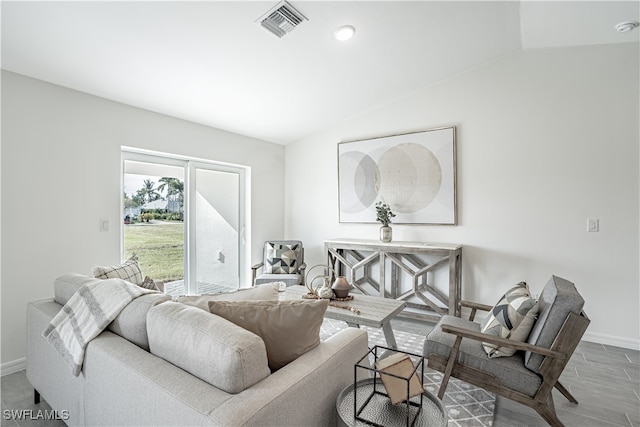 living room with hardwood / wood-style floors and lofted ceiling