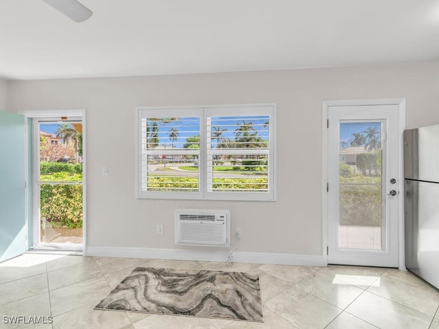 interior space with light tile patterned flooring and a wall mounted AC