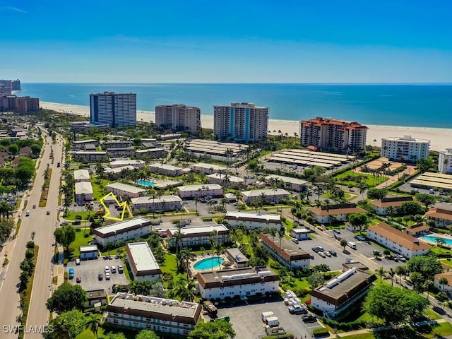 birds eye view of property with a beach view and a water view