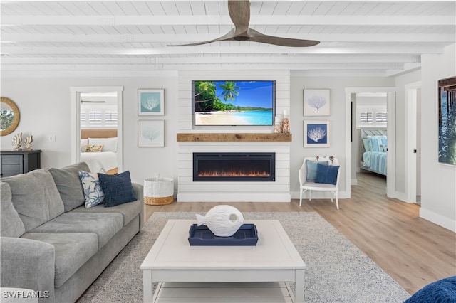 living room featuring beam ceiling, ceiling fan, wood ceiling, and light wood-type flooring