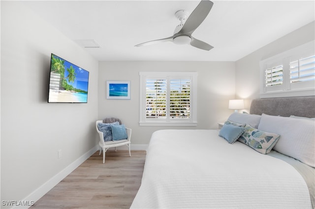 bedroom with light hardwood / wood-style floors and ceiling fan