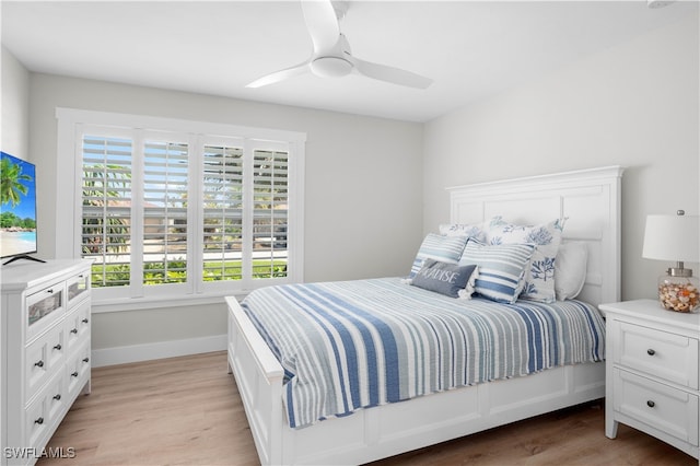 bedroom with ceiling fan and light hardwood / wood-style floors