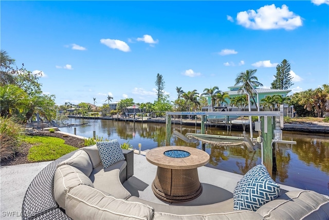 dock area with a water view and an outdoor living space with a fire pit