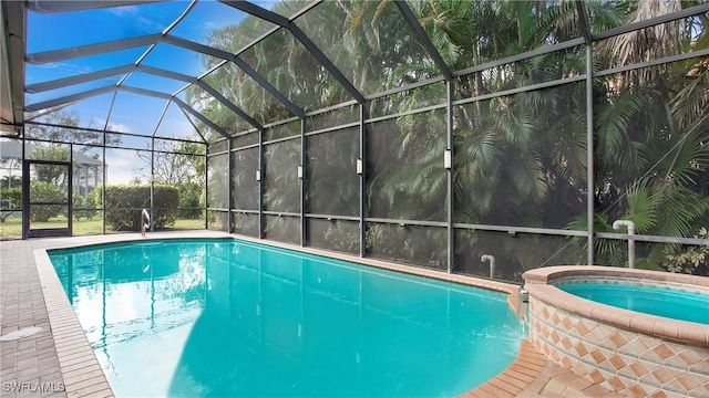 view of swimming pool featuring a lanai and an in ground hot tub