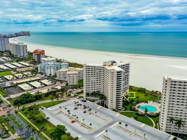 drone / aerial view featuring a water view and a view of the beach