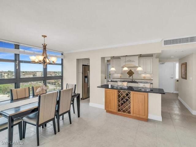 260 Seaview Ct Unit 803, Marco Island, FL 34145 - dining space featuring light tile patterned floors, crown molding, visible vents, a chandelier, and baseboards