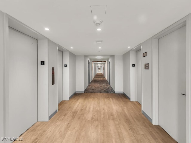 260 Seaview Ct Unit 803, Marco Island, FL 34145 - hall featuring light wood-style floors, recessed lighting, elevator, and baseboards