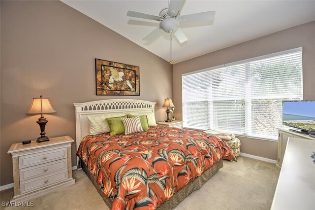 bedroom with ceiling fan, light carpet, and vaulted ceiling