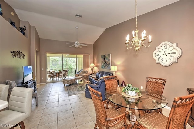 dining space featuring ceiling fan with notable chandelier, light tile patterned floors, and high vaulted ceiling