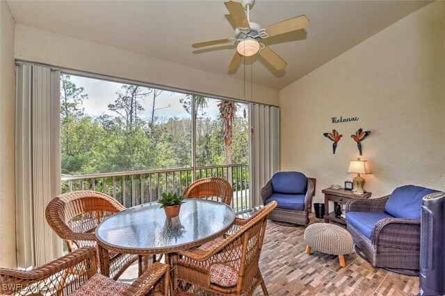 sunroom / solarium with ceiling fan and vaulted ceiling