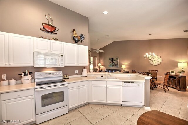 kitchen with white cabinetry, sink, kitchen peninsula, white appliances, and vaulted ceiling