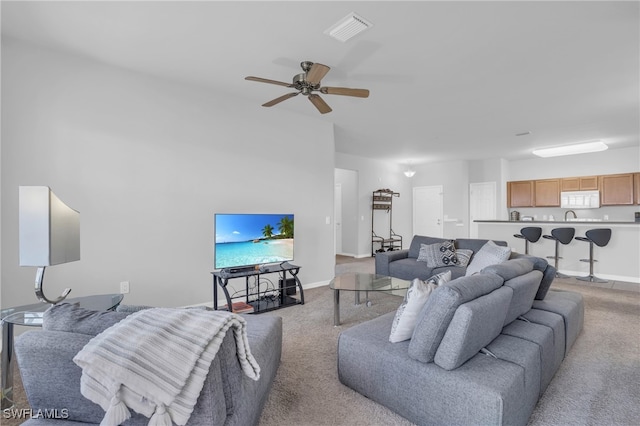 living room featuring light colored carpet and ceiling fan