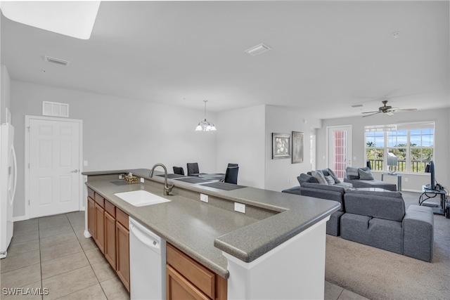 kitchen with ceiling fan with notable chandelier, dishwasher, sink, an island with sink, and decorative light fixtures