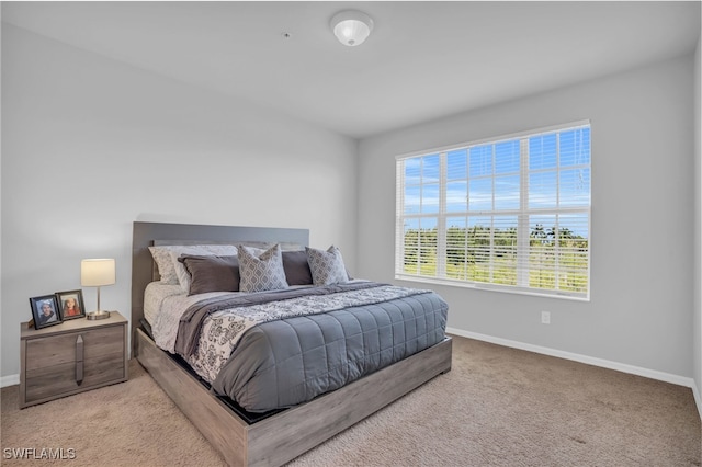 bedroom featuring light carpet