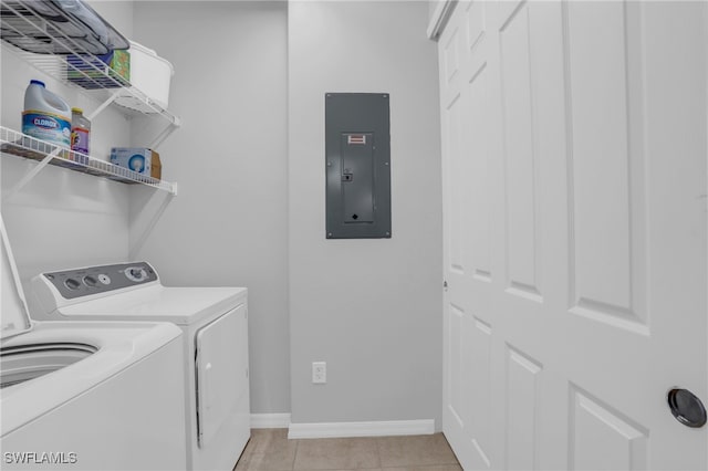 laundry area featuring electric panel, light tile patterned floors, and separate washer and dryer