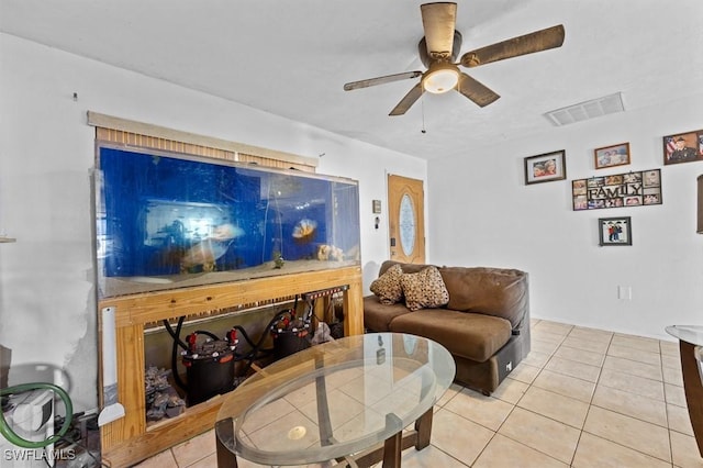 living area with visible vents, ceiling fan, and light tile patterned flooring