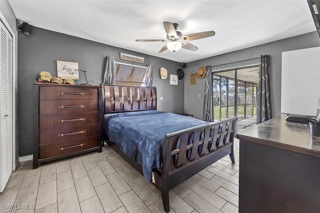 bedroom with ceiling fan, access to exterior, and wood tiled floor