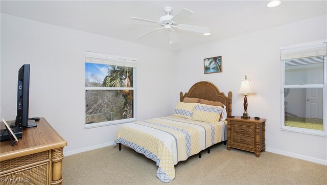 bedroom with light carpet and ceiling fan