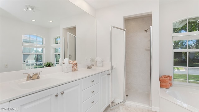 bathroom with vanity, tile patterned floors, and separate shower and tub