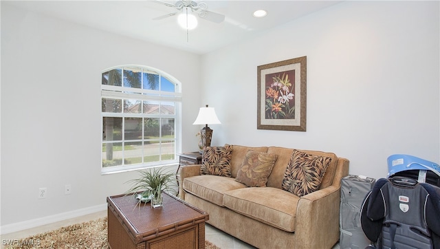 living room featuring a wealth of natural light and ceiling fan