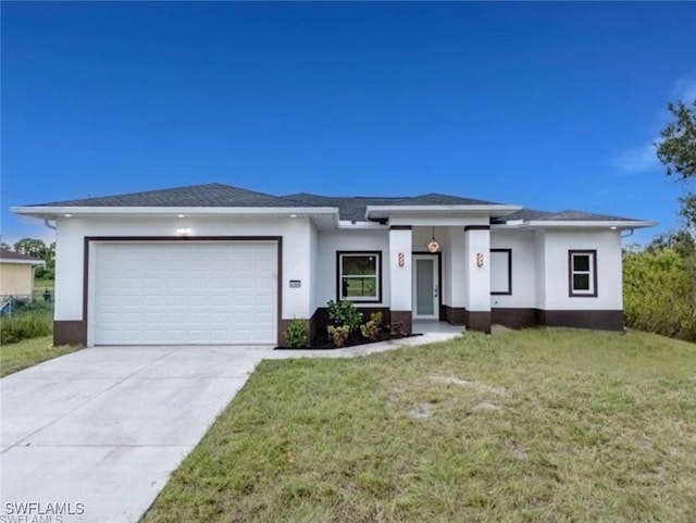 view of front of property featuring a garage and a front yard