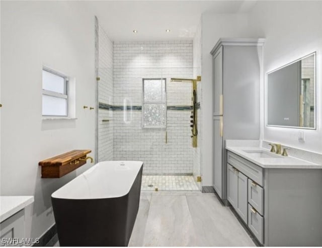 bathroom featuring vanity and shower with separate bathtub