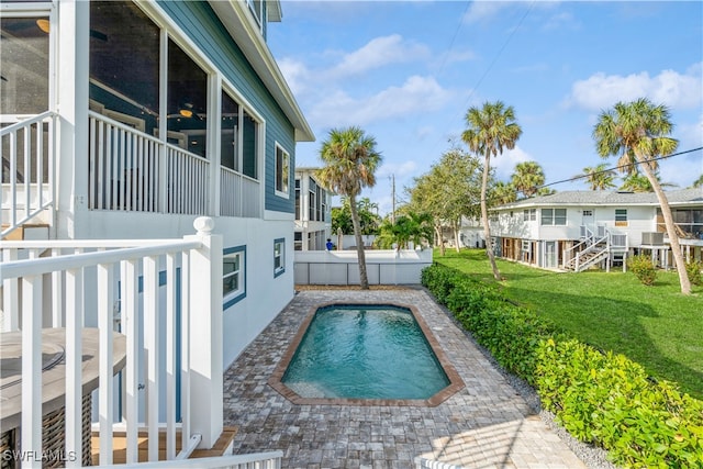 view of swimming pool with a lawn and a patio