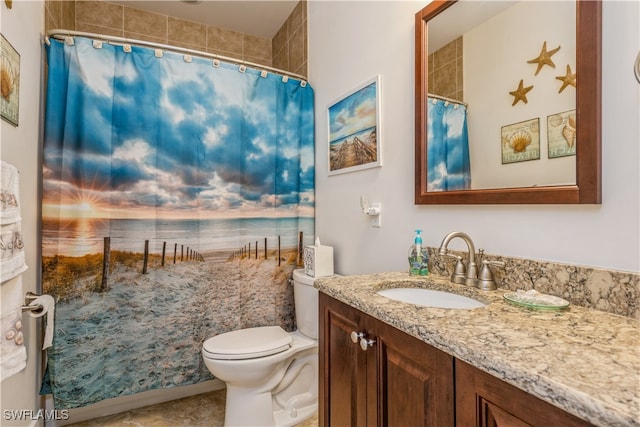 bathroom with vanity, curtained shower, and toilet