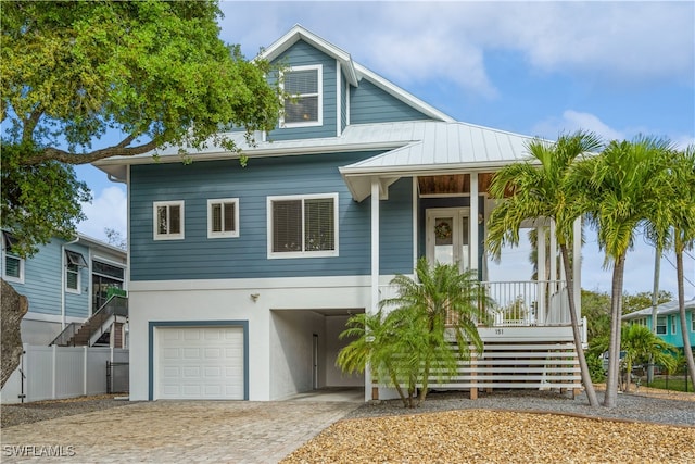 view of front of house with a porch and a garage