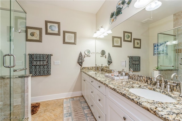 bathroom featuring tile patterned flooring, vanity, and a shower with door