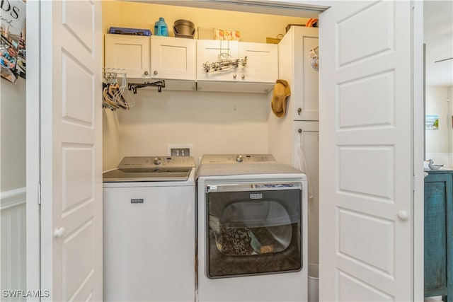 clothes washing area with separate washer and dryer