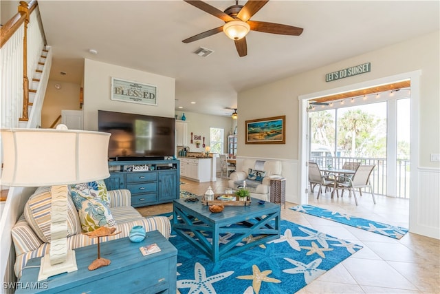 living room featuring ceiling fan and light tile patterned floors