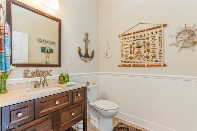 bathroom featuring tile patterned floors, vanity, and toilet