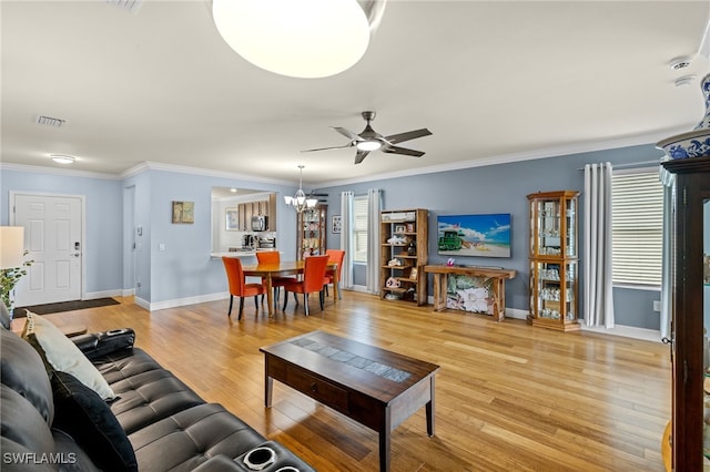 living room featuring ornamental molding, ceiling fan with notable chandelier, and light hardwood / wood-style flooring