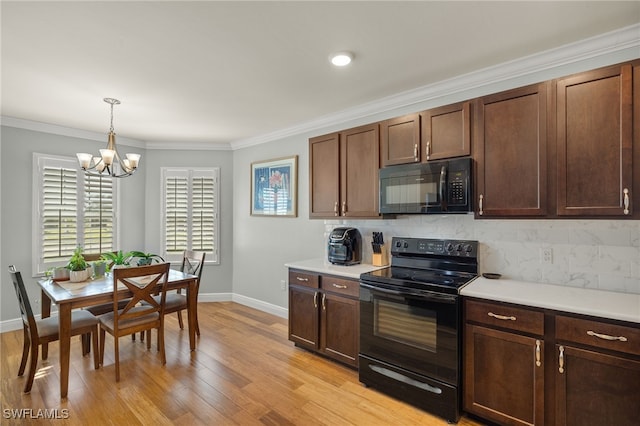 kitchen featuring black appliances, hanging light fixtures, ornamental molding, and light hardwood / wood-style flooring