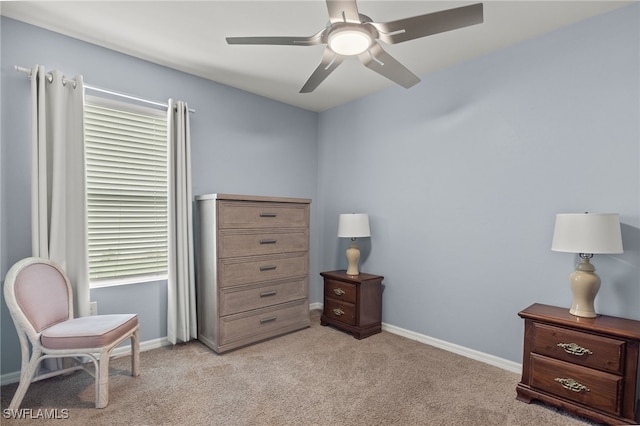 living area with ceiling fan, light carpet, and a healthy amount of sunlight