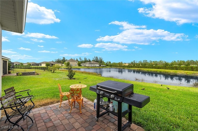 view of patio featuring a water view and grilling area