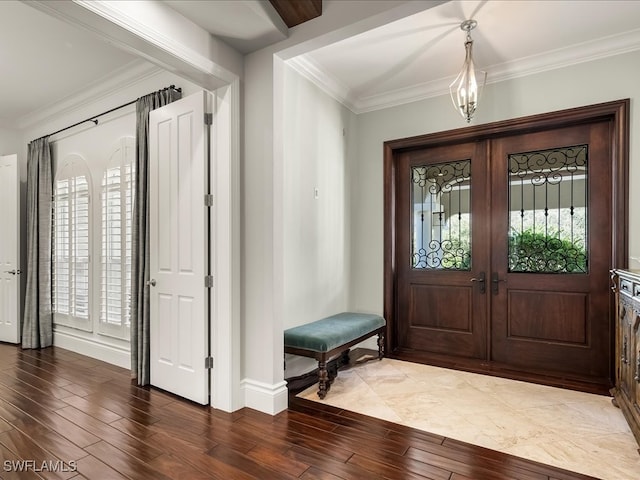 foyer entrance with hardwood / wood-style floors, a wealth of natural light, and crown molding