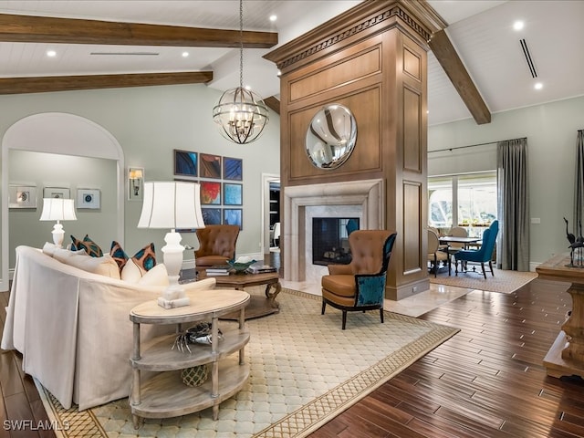 living room featuring beam ceiling, a premium fireplace, and hardwood / wood-style floors