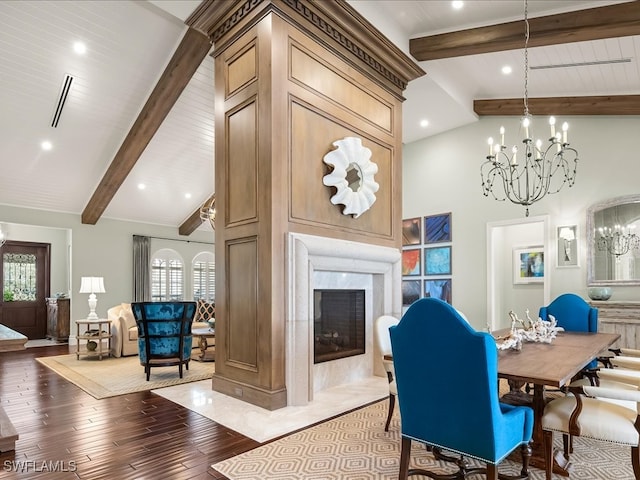 dining area featuring beam ceiling, a high end fireplace, high vaulted ceiling, a chandelier, and wood-type flooring