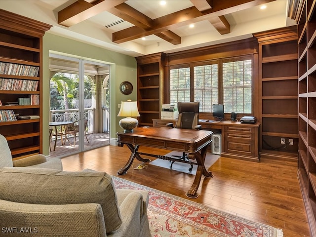 office area with coffered ceiling, plenty of natural light, beam ceiling, and light hardwood / wood-style flooring