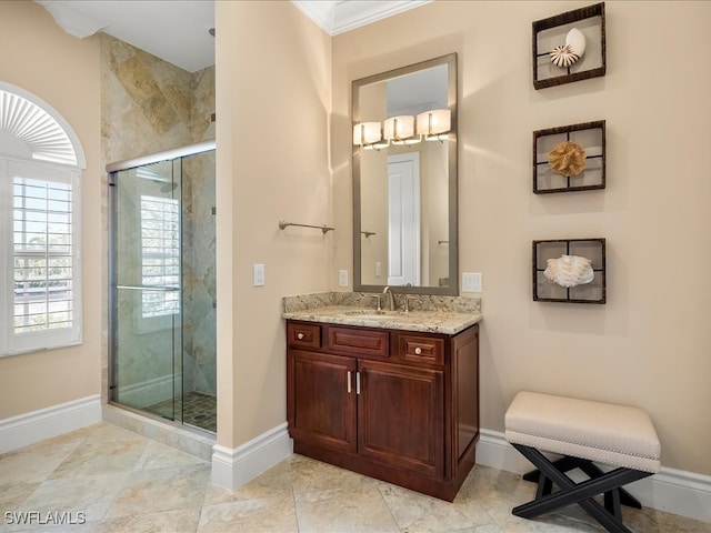 bathroom featuring vanity, a shower with shower door, and crown molding