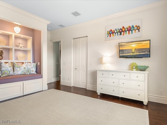 unfurnished bedroom with dark hardwood / wood-style flooring, a closet, and crown molding