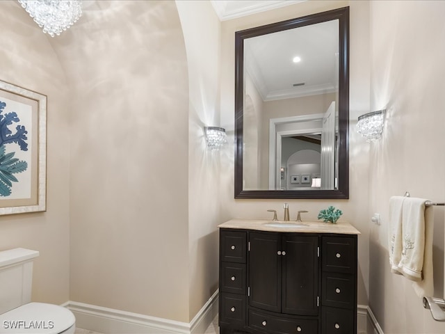 bathroom featuring vanity, toilet, and crown molding