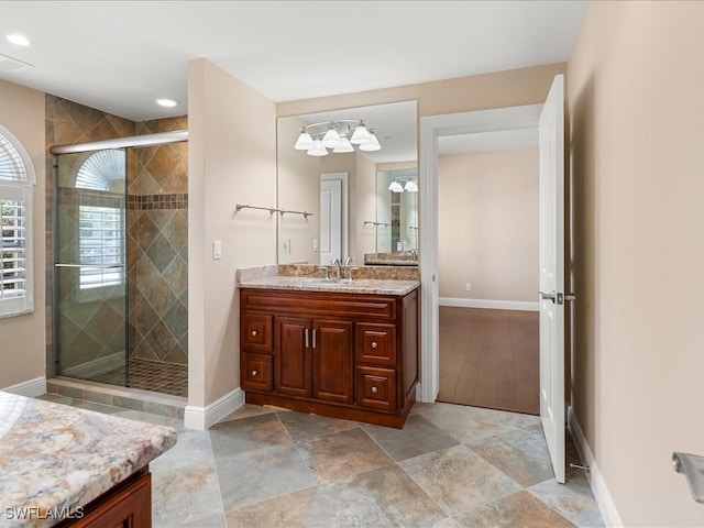 bathroom featuring vanity and an enclosed shower