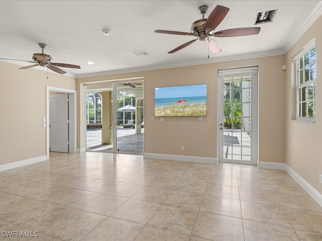 tiled spare room with ceiling fan, ornamental molding, and a wealth of natural light