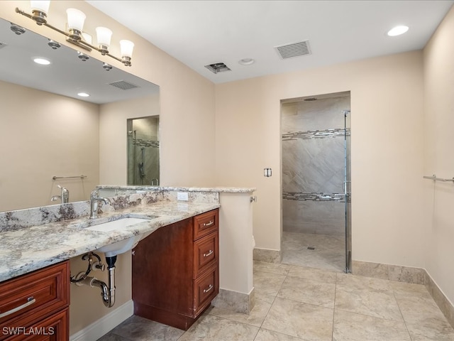 bathroom featuring tile patterned floors, walk in shower, and sink