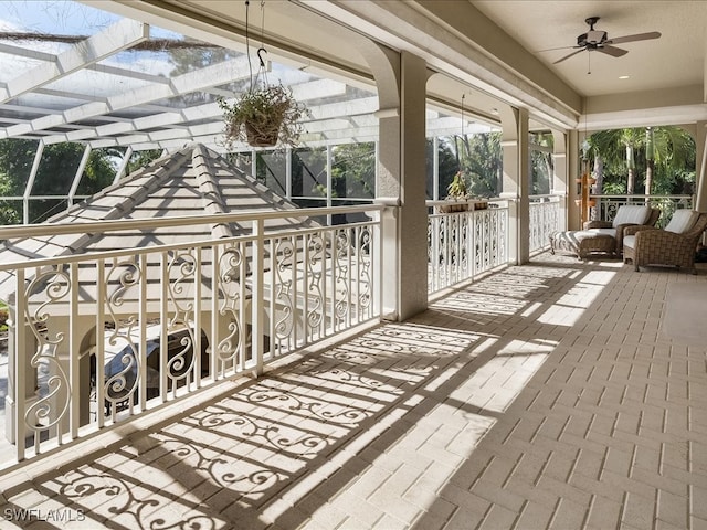 sunroom / solarium featuring ceiling fan