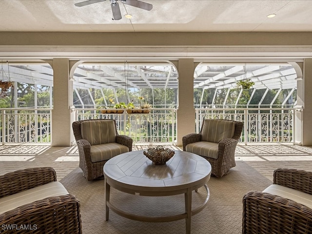 sunroom / solarium featuring ceiling fan