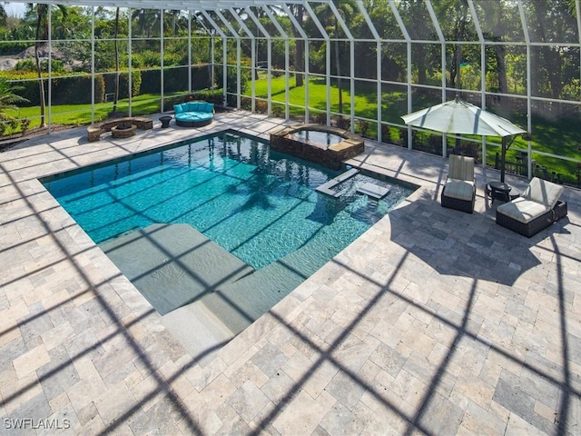 view of pool featuring glass enclosure, a yard, an outdoor fire pit, an in ground hot tub, and a patio